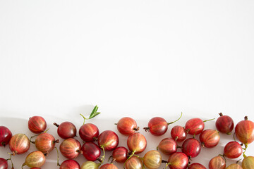 red berries of gooseberry on white with space 