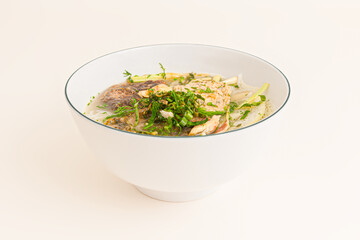 Bun ca ro dong, Vietnamese rice noodles and anbas fish soup, Vietnamese food isolated on white background, perspective view
