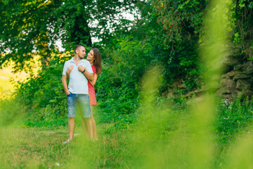 girl hugs the guy from the back side in the park