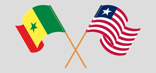 Crossed and waving flags of Senegal and Liberia