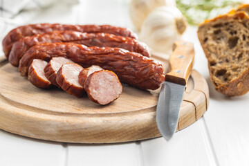 Smoked pork sausages. Sliced salami