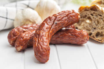Smoked pork sausages. Sliced salami