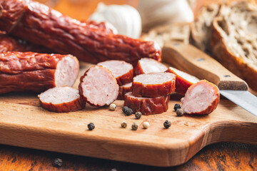 Smoked pork sausages. Sliced salami
