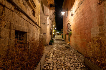  Cobblestone street in the Sassi di Matera a historic district in the city of Matera. Basilicata. Italy