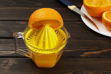 Handmade juice, juicer for citrus fruits squeeze fresh juice from halves of oranges for healthy nutrition