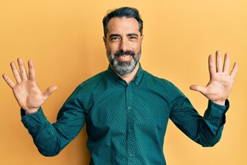 Middle age man with beard and grey hair wearing business clothes showing and pointing up with fingers number ten while smiling confident and happy.