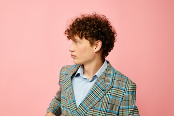 portrait of a young curly man gesturing with his hands emotions checkered jacket isolated background unaltered