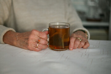 Senior woman holding a glass of tea