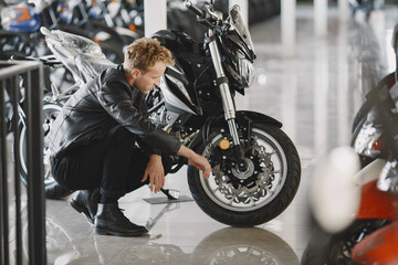 Fototapeta na wymiar Handsome man choosing a motorcycle to buy