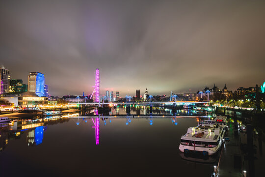 Evening skyline of London seen across Thames river 
