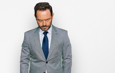 Middle age man wearing business clothes skeptic and nervous, frowning upset because of problem. negative person.