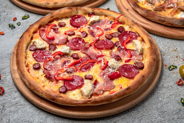 Pizza party dinner. Flat-lay of different kinds of Tasty hot Italian pizza on a beige textured background. Fast food lunch, gathering, celebration. Pizzeria 