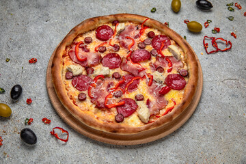 Tasty hot italian pizza with Mozzarella, Pepperoni, pastrami, hunting sausages and Tomato Sauce on a beige textured background. Pizzeria menu. 