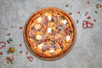 Tasty hot italian pizza with Mozzarella, Prosciutto, fried mushrooms and Tomato Sauce on a beige textured background. Pizzeria menu. 