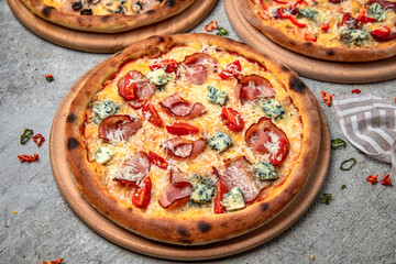 Pizza party dinner. Flat-lay of different kinds of Tasty hot Italian pizza on a beige textured background. Fast food lunch, gathering, celebration. Pizzeria 