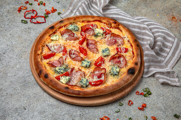 Tasty hot italian pizza with Mozzarella, Doblu, hunting sausages, pepper and Tomato Sauce on a beige textured background. Pizzeria menu. 
