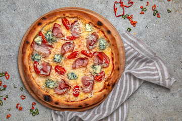 Tasty hot italian pizza with Mozzarella, Doblu, hunting sausages, pepper and Tomato Sauce on a beige textured background. Pizzeria menu. 