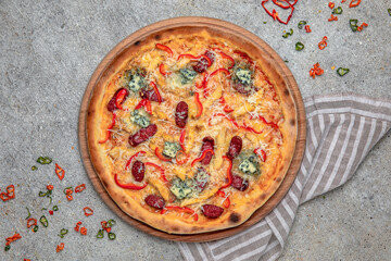 Tasty hot italian pizza with Mozzarella, Doblu, hunting sausages, pepper and Tomato Sauce on a beige textured background. Pizzeria menu. 