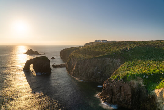 Land's End with Enys Dodman arch sunset in Cornwall. United Kiongdom