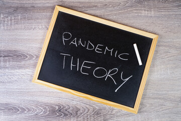 pandemic theory written with chalk on a blackboard