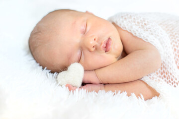 Newborn baby sleeping on a white background. Selective focus.