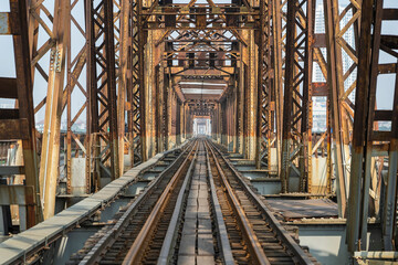Ancient train steel bridge Long Bien railway with pedestrian through a river in Hanoi, Vietnam