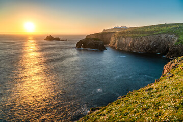Land's End with Enys Dodman arch sunset in Cornwall. United Kiongdom