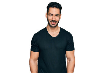 Obraz premium Hispanic man with beard wearing casual black t shirt with a happy and cool smile on face. lucky person.