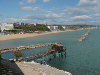 Fototapeta premium ancient fishing machine in the sea called Trabucco along the city walls the Swabian Castle in Termoli