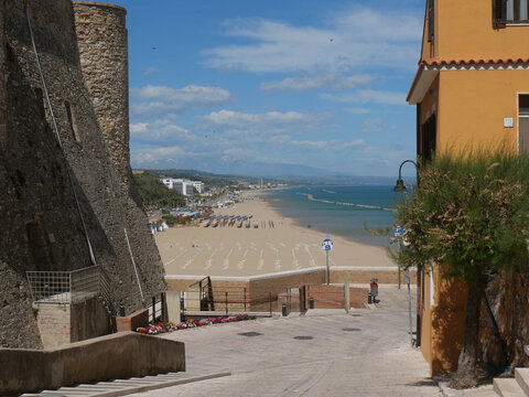 Montecastello street with colorful buildings and the sea in the background along the city walls the Swabian Castle in Termoli