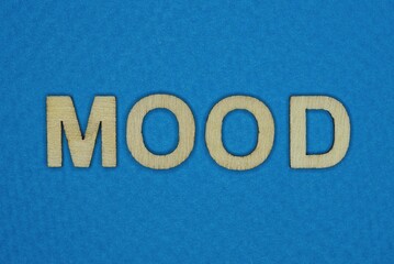 gray word mood in small wooden letters on a blue background