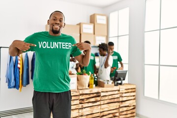 Group of young african american volunteers working at charity center. Man smiling happy and...