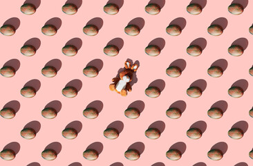 Pattern of easter eggs on coral pastel background