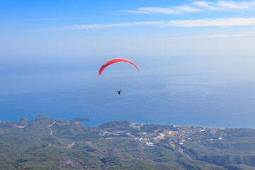 Paragliders flying from a top of Tahtali mountain near Kemer, Antalya Province in Turkey. Concept of active lifestyle and extreme sport adventure