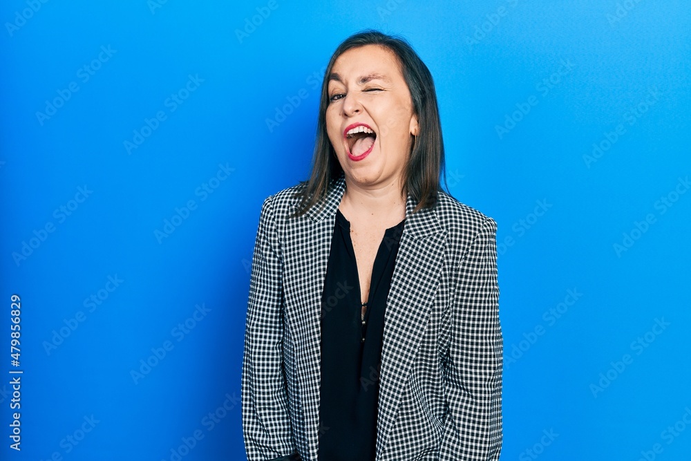 Sticker middle age hispanic woman wearing business clothes winking looking at the camera with sexy expressio