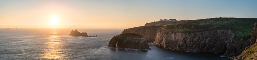 Land's End with Enys Dodman arch at sunset, Cornwall. United Kingdom