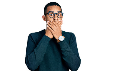 Young african american man wearing casual clothes and glasses shocked covering mouth with hands for...