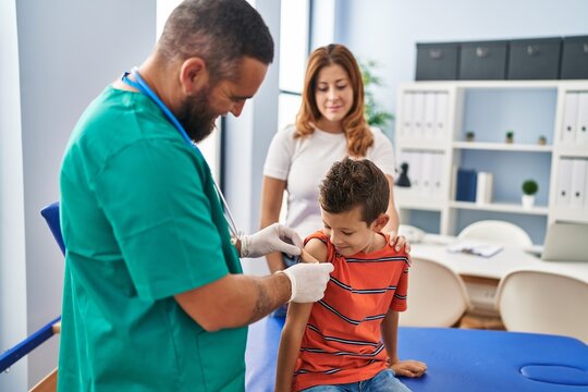 Family vaccinating child having medical consultation at clinic