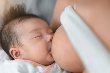 Mother breastfeed baby, Close-up of little asian infant,  Breast milk  newborn food concept.;