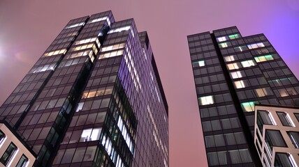 Office building at night, building facade with glass and lights. View with illuminated modern skyscraper. - obrazy, fototapety, plakaty