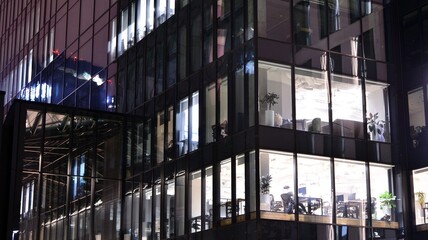 Office building at night, building facade with glass and lights. View with illuminated modern skyscraper. © Grand Warszawski