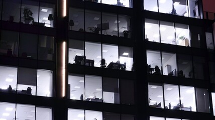 Office building at night, building facade with glass and lights. View with illuminated modern skyscraper. © Grand Warszawski