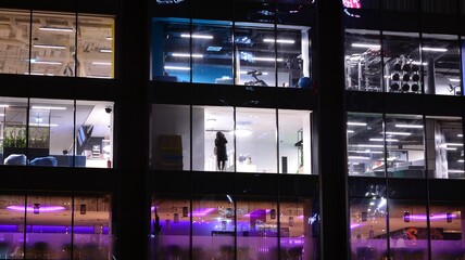 Office building at night, building facade with glass and lights. View with illuminated modern skyscraper. © Grand Warszawski