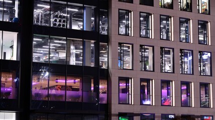 Office building at night, building facade with glass and lights. View with illuminated modern skyscraper. © Grand Warszawski