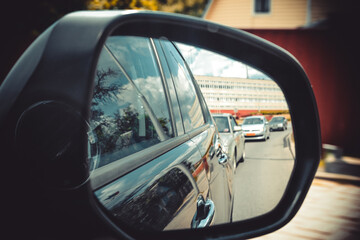Fototapeta na wymiar Reflection in the car mirror