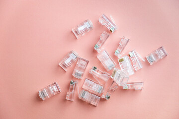 Transparent ethernet internet RJ-45 connectors, tehnology background on pink with hand