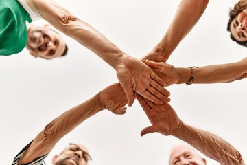 Group of middle age friends with hands together.