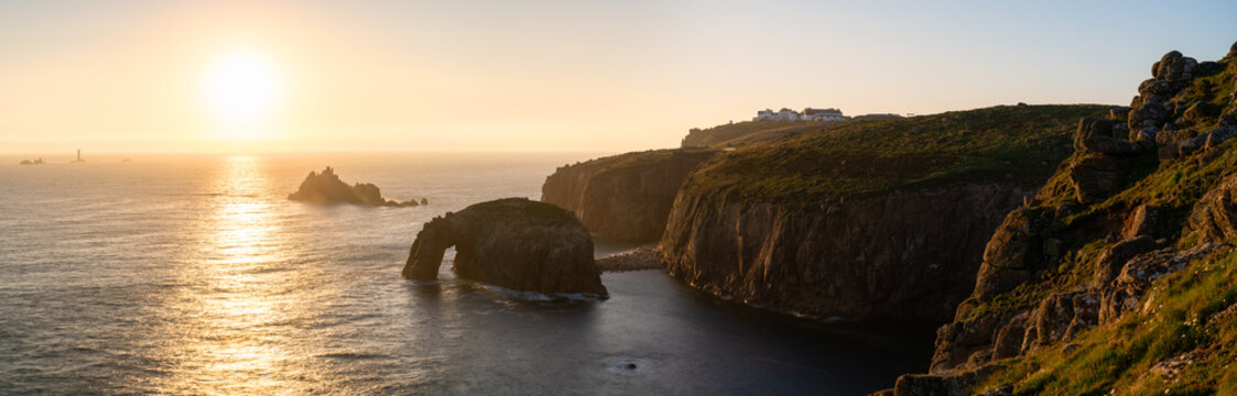 Land's End with Enys Dodman arch at sunset, Cornwall. United Kingdom