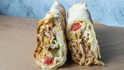 Shawarma chicken roll. Fresh roll of thin lavash or pita bread filled with grilled meat, cheese,...