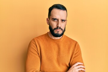 Young man with beard wearing casual winter sweater skeptic and nervous, disapproving expression on...